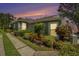 Charming home with a well-manicured lawn and colorful landscaping, showcasing its inviting curb appeal at 6041 Sandhill Ridge Dr, Lithia, FL 33547