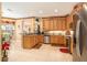 Bright kitchen featuring stainless steel appliances, tile flooring, and bar-top counter at 6041 Sandhill Ridge Dr, Lithia, FL 33547