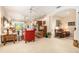 Large living room with ceiling fans, elegant columns, comfortable seating, and a view of the outdoor area at 6041 Sandhill Ridge Dr, Lithia, FL 33547
