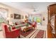 Comfortable living room with a ceiling fan, classic decor, and natural light streaming through the sliding glass door at 6041 Sandhill Ridge Dr, Lithia, FL 33547