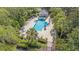 Community pool surrounded by lush landscaping, lounge chairs, and tables for residents enjoyment at 6041 Sandhill Ridge Dr, Lithia, FL 33547