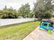 Landscaped backyard featuring a privacy fence, grill, and outdoor play center at 630 Timber Bay W Cir, Oldsmar, FL 34677