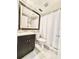 Cozy bathroom featuring a framed mirror, toilet, and shower with curtain at 630 Timber Bay W Cir, Oldsmar, FL 34677