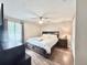 Cozy bedroom with hardwood floors, a ceiling fan, and a comfortable queen-sized bed at 630 Timber Bay W Cir, Oldsmar, FL 34677