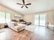 Bright living room featuring hardwood floors, a ceiling fan, and sliding glass doors at 630 Timber Bay W Cir, Oldsmar, FL 34677