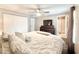 Bright main bedroom featuring a ceiling fan, closet, and a private bathroom at 630 Timber Bay W Cir, Oldsmar, FL 34677