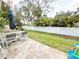 This home features a patio with outdoor furniture, a grill, and a fully fenced yard at 630 Timber Bay W Cir, Oldsmar, FL 34677