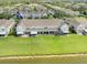 Aerial view of a townhouse complex with landscaped green spaces and community amenities, offering a serene residential setting at 637 Kensington Lake Cir, Brandon, FL 33511