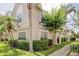 Attractive two-story townhouse with well-maintained landscaping and mature trees enhancing its curb appeal and charm at 637 Kensington Lake Cir, Brandon, FL 33511