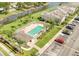 Aerial view of community pool with palm trees, lounge chairs, and a parking lot at 637 Kensington Lake Cir, Brandon, FL 33511