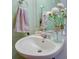 Stylish bathroom sink features a decorative towel, floral accents, and mirror, blending functionality and style at 637 Kensington Lake Cir, Brandon, FL 33511