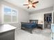 Comfortable bedroom features carpeted floor, ceiling fan, and large window with shutters at 6905 Arabian Rd, Odessa, FL 33556