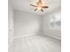 Bright bedroom with a ceiling fan, neutral paint, carpet and plantation shutters at 6905 Arabian Rd, Odessa, FL 33556