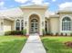 Charming one story home with a beautiful landscaped front yard, arched entry and white tile roof at 6905 Arabian Rd, Odessa, FL 33556