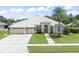 Charming home with a well-manicured lawn, mature landscaping, and welcoming front entrance at 6905 Arabian Rd, Odessa, FL 33556