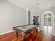 Game room with pool table and hardwood floors with an entryway view at 6905 Arabian Rd, Odessa, FL 33556