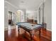 Open floor plan in game room with pool table and hardwood floors at 6905 Arabian Rd, Odessa, FL 33556
