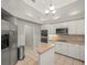 Bright kitchen featuring modern appliances, white cabinets and tile floors at 6905 Arabian Rd, Odessa, FL 33556
