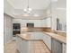 Bright kitchen features modern appliances, white cabinets and tile floors at 6905 Arabian Rd, Odessa, FL 33556
