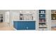 Open concept kitchen with breakfast bar, built-in shelves and seamless access to living area at 6905 Arabian Rd, Odessa, FL 33556