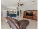 Open concept living room with a breakfast bar, tile floors, and a view into the kitchen at 6905 Arabian Rd, Odessa, FL 33556