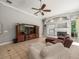 Spacious living room with tile floors, fireplace, ceiling fan and entertainment center at 6905 Arabian Rd, Odessa, FL 33556