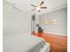 Spacious main bedroom with hardwood floors, ceiling fan and large windows for ample natural light at 6905 Arabian Rd, Odessa, FL 33556