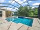 Screened in pool area with in-ground spa and clear blue swimming pool at 6905 Arabian Rd, Odessa, FL 33556