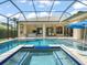 Inviting screened in pool area with an in-ground spa, outdoor furniture, and serene blue pool at 6905 Arabian Rd, Odessa, FL 33556