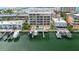 Stunning aerial view of waterfront condo with private boat slips and pool, set against a coastal backdrop at 706 Bayway Blvd # 503, Clearwater, FL 33767