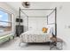 Cozy bedroom featuring a canopy bed and large window with water views at 706 Bayway Blvd # 503, Clearwater, FL 33767