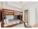 Cozy bunk room featuring a wooden bunk bed frame and closet with storage at 706 Bayway Blvd # 503, Clearwater, FL 33767