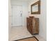 Condo foyer with decorative mirror and wood cabinet, providing a stylish welcome at 706 Bayway Blvd # 503, Clearwater, FL 33767