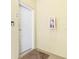 Condo hallway featuring a secure white entry door, apartment number, and a wall-mounted fire extinguisher at 706 Bayway Blvd # 503, Clearwater, FL 33767