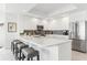 Elegant kitchen island with bar seating, complemented by stainless steel appliances and bright lighting at 706 Bayway Blvd # 503, Clearwater, FL 33767