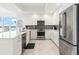 Bright kitchen featuring stainless steel appliances, modern fixtures, and sleek white cabinetry at 706 Bayway Blvd # 503, Clearwater, FL 33767