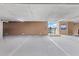Secured parking garage area with marked reserved parking spaces and gate leading to the pool and deck area on the 4th floor at 706 Bayway Blvd # 503, Clearwater, FL 33767