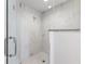 Shower featuring sleek marble tiling and frameless glass door at 706 Bayway Blvd # 503, Clearwater, FL 33767