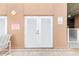 Exterior ground level white door storage area in an enclosed common area with security notice and alarm sounds spa pump is shut off sign at 706 Bayway Blvd # 503, Clearwater, FL 33767