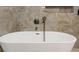 Close up of a luxurious freestanding tub featuring modern, sleek fixtures and a hand shower at 711 42Nd S Ave, St Petersburg, FL 33705