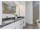 Bathroom featuring double sink, white cabinets, marble countertop and backsplash at 711 42Nd S Ave, St Petersburg, FL 33705