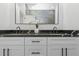 Modern bathroom featuring dual sinks, sleek black countertop, and white cabinetry at 711 42Nd S Ave, St Petersburg, FL 33705
