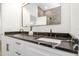 Bathroom featuring double sink with white cabinetry and black marble countertop at 711 42Nd S Ave, St Petersburg, FL 33705