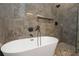 Close-up of freestanding tub with marble-tiled backsplash and modern fixtures at 711 42Nd S Ave, St Petersburg, FL 33705