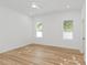 Bright, airy bedroom with wood flooring, two windows offering ample natural light and backyard views at 711 42Nd S Ave, St Petersburg, FL 33705