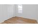 Bright bedroom with wood flooring, a window, and a spacious closet with white doors at 711 42Nd S Ave, St Petersburg, FL 33705