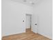 Minimalist bedroom with wood flooring, white walls and trim, and a bright window at 711 42Nd S Ave, St Petersburg, FL 33705