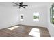 A serene bedroom bathed in natural light, featuring hardwood floors, and white walls that enhance spaciousness at 711 42Nd S Ave, St Petersburg, FL 33705