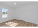 This bedroom features wood floors, recessed lighting, a ceiling fan, and a bright window overlooking the yard at 711 42Nd S Ave, St Petersburg, FL 33705