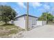 Rear exterior view showing a garage, white fence, and gravel yard at 711 42Nd S Ave, St Petersburg, FL 33705